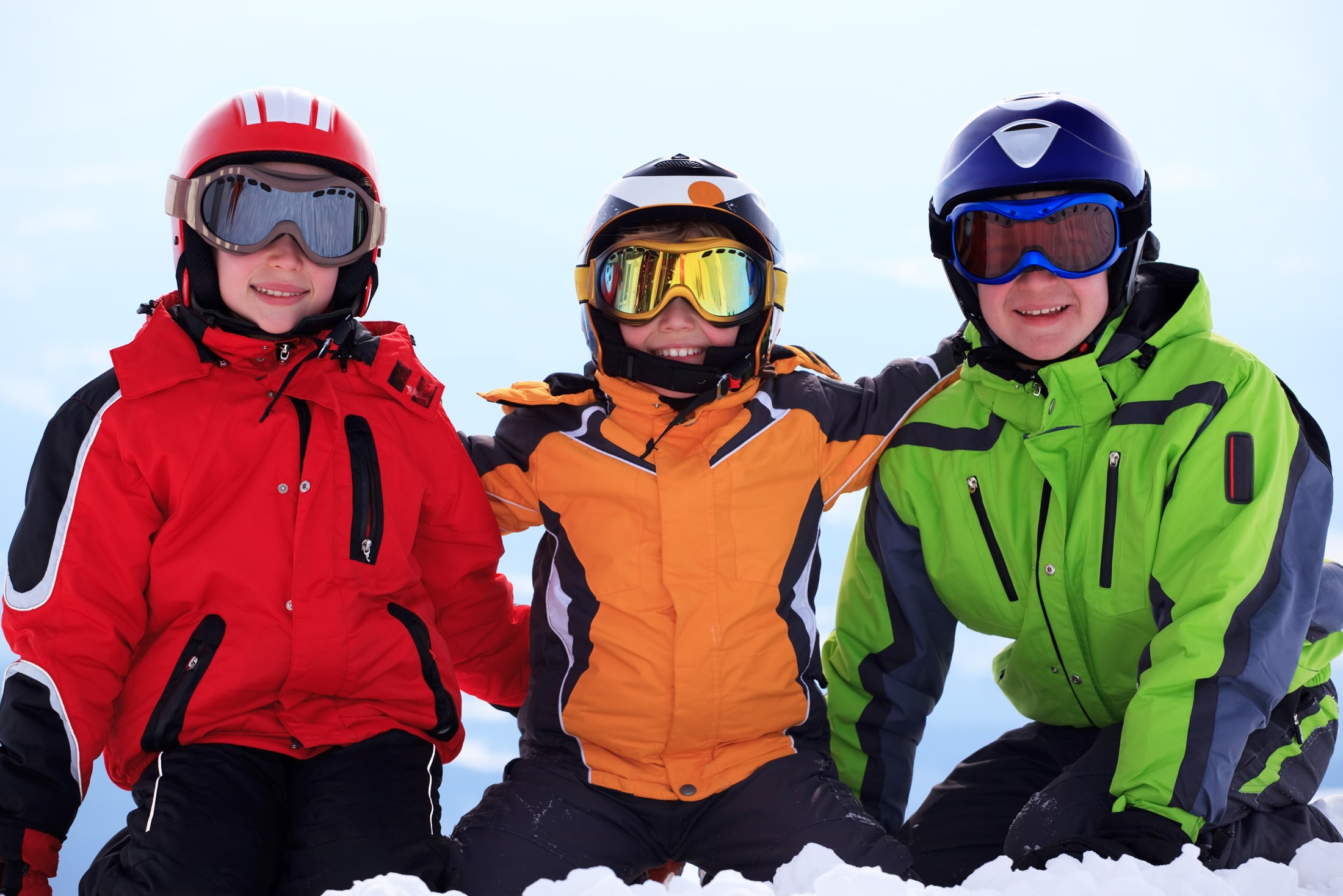 Three school students in the snow on a ski trip